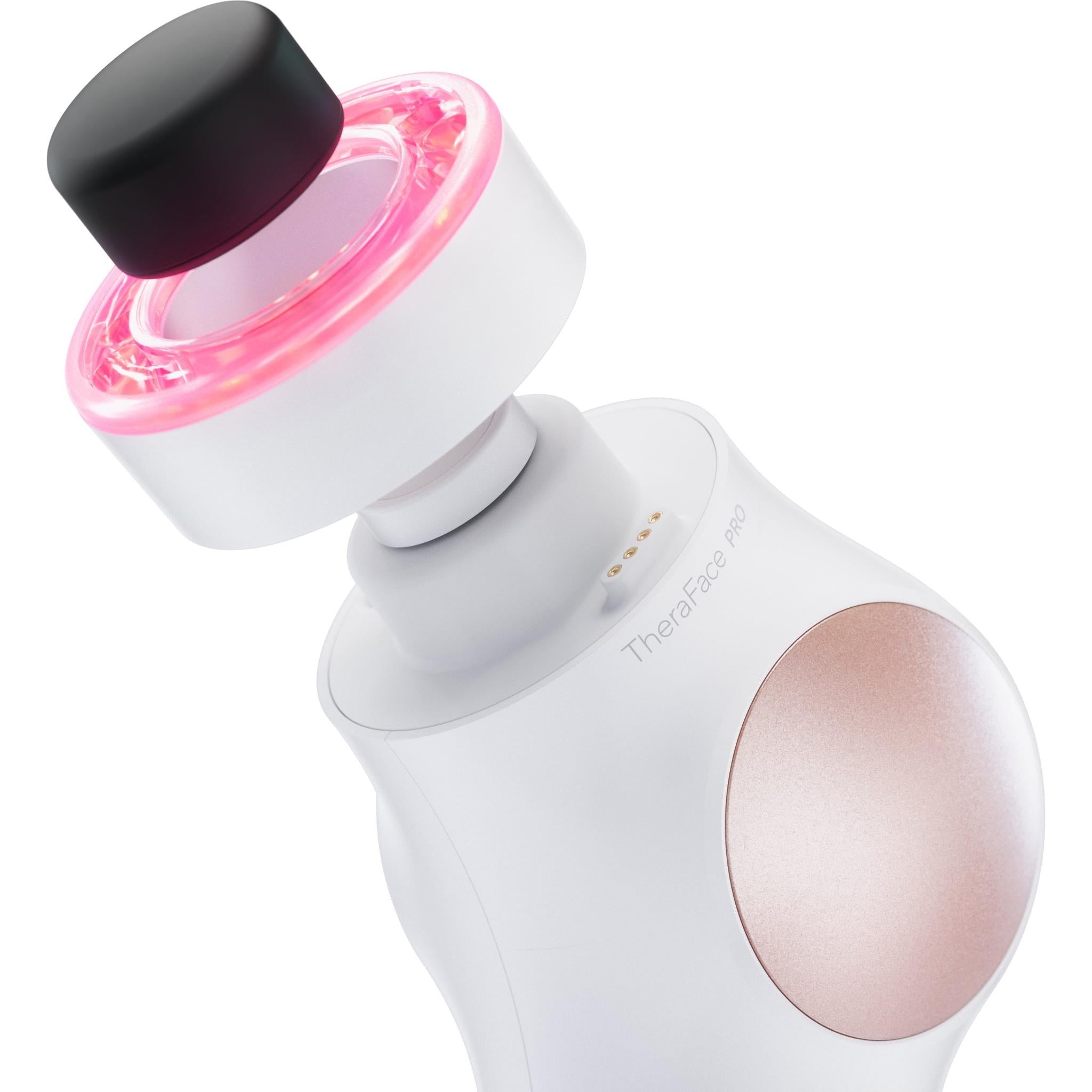 White facial therapy device with pink LED ring and black cap attachment