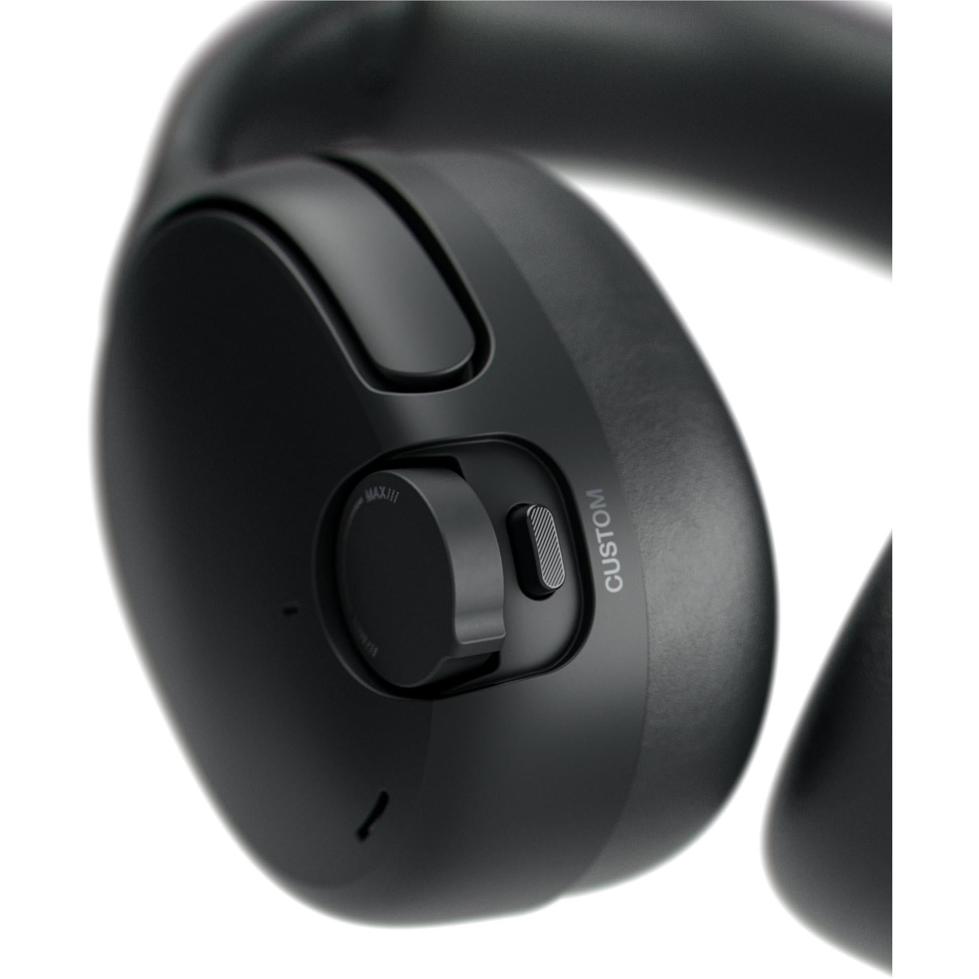 Black headphone earcup with close-up of control dial and padded housing