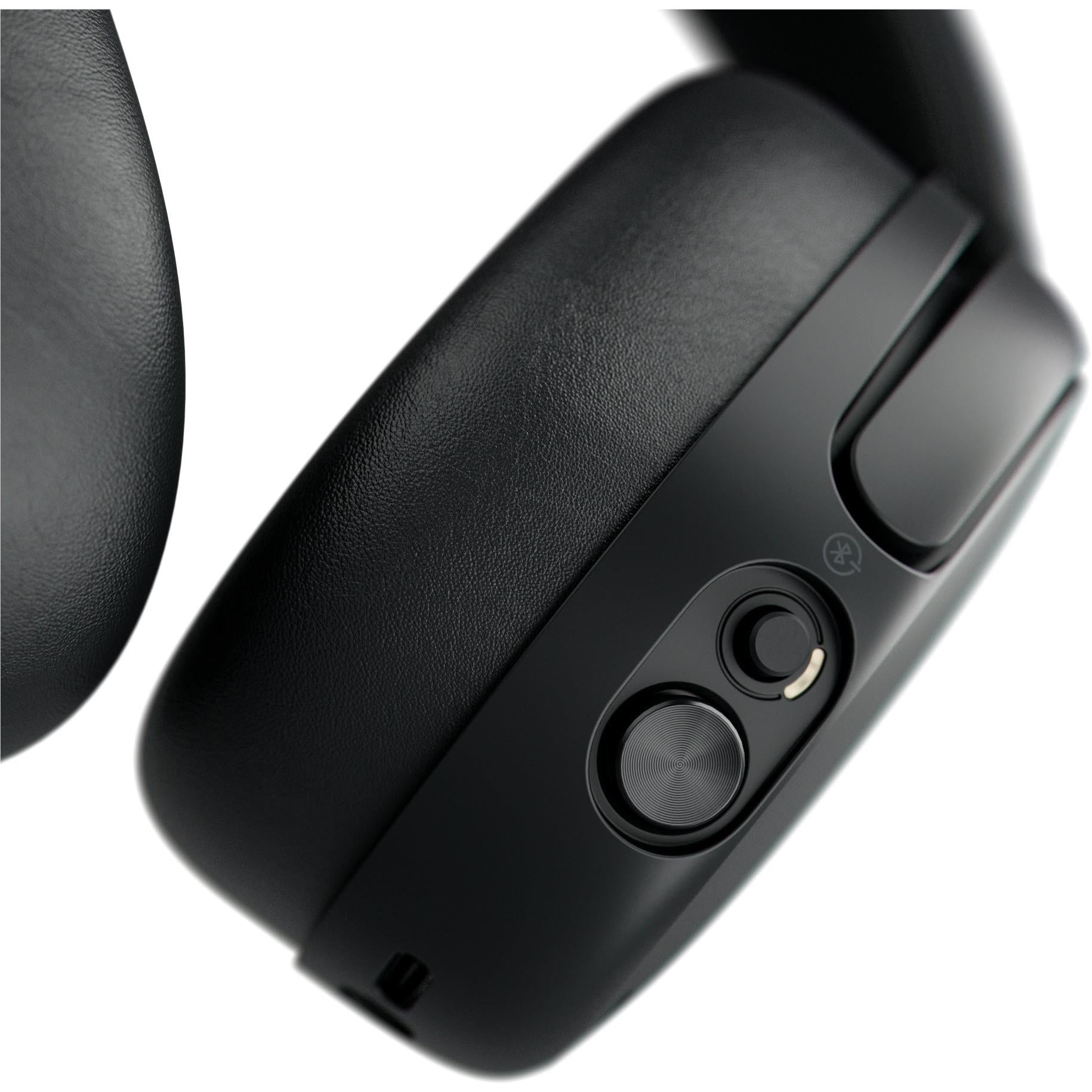 Black headphone earcup side with textured controls and round button