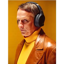 Man wearing black over-ear Bluetooth headphones with adjustable headband