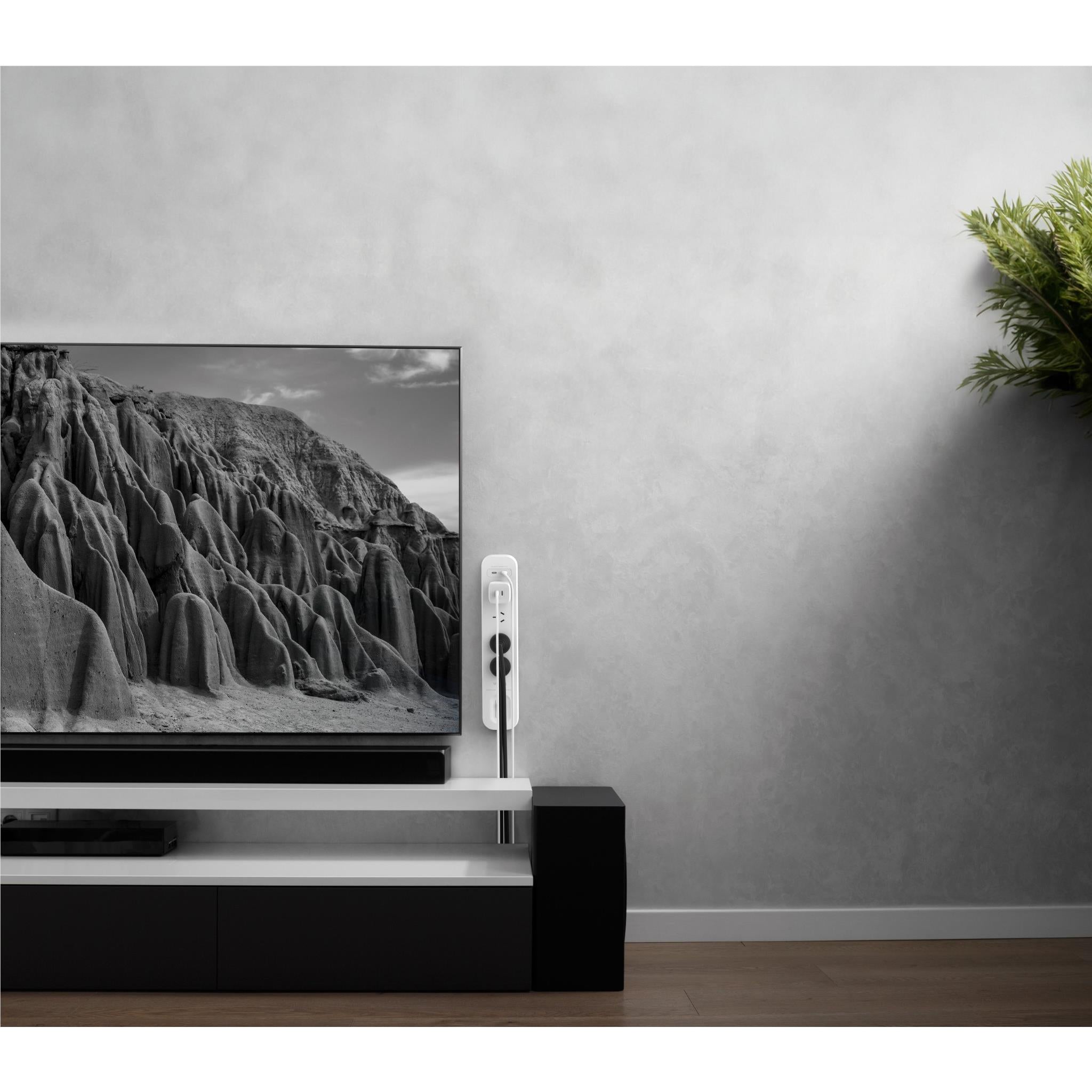 Wall-mounted white surge protector with four outlets and dual USB-C ports