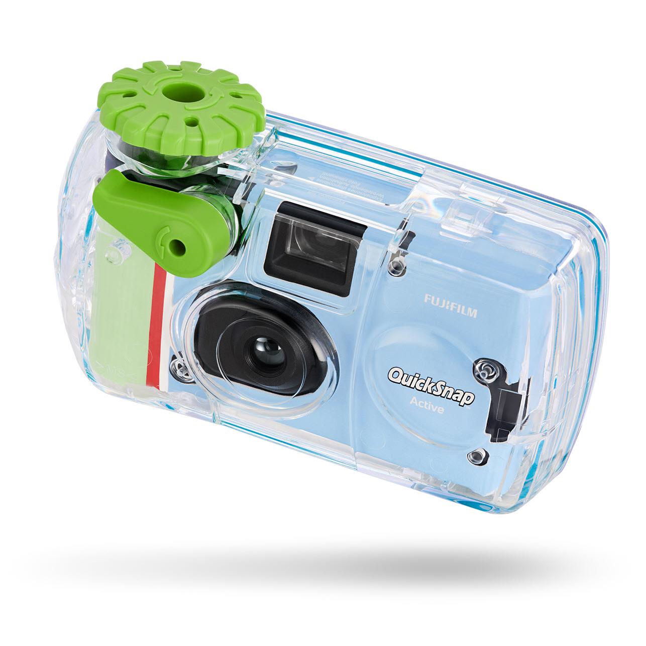 Three-quarter view of clear disposable camera with green top and red side stripe.