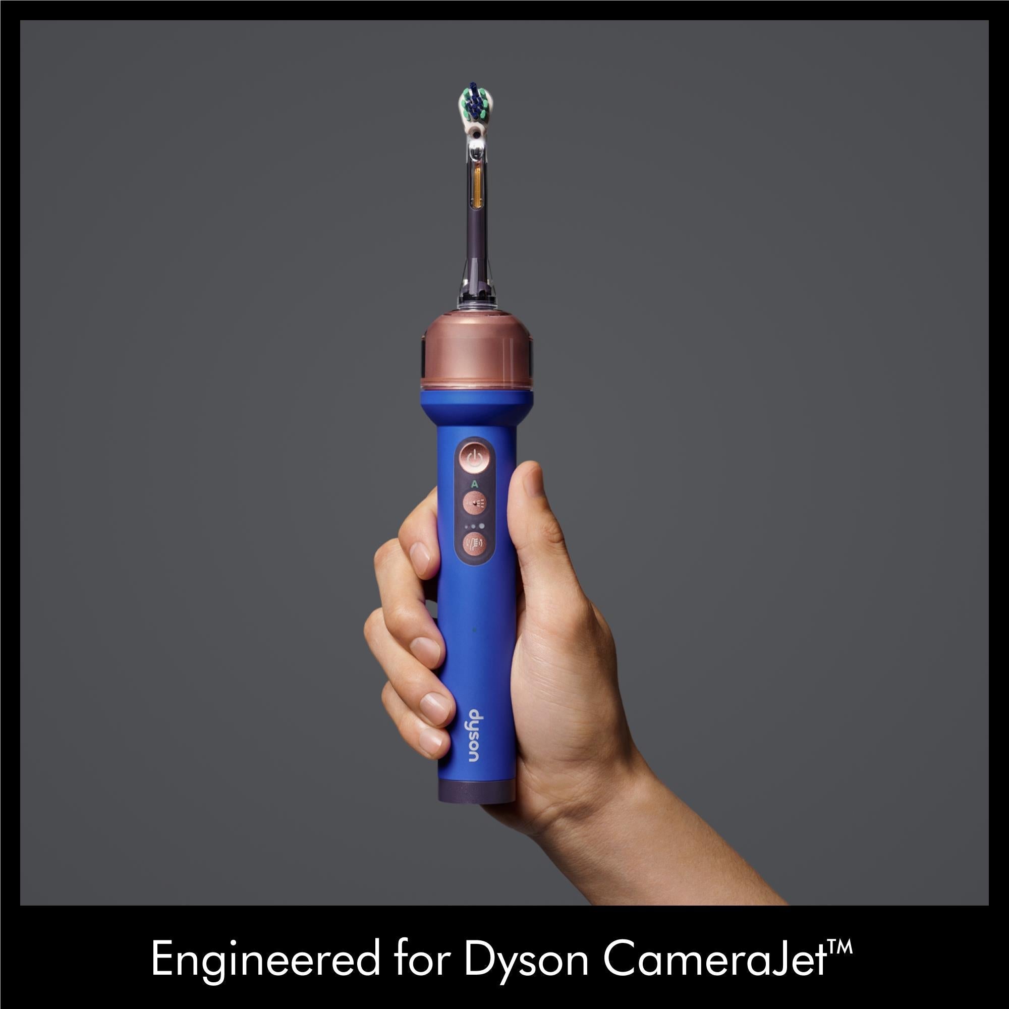 Dyson dual-bristle brush head on a blue and purple handheld unit