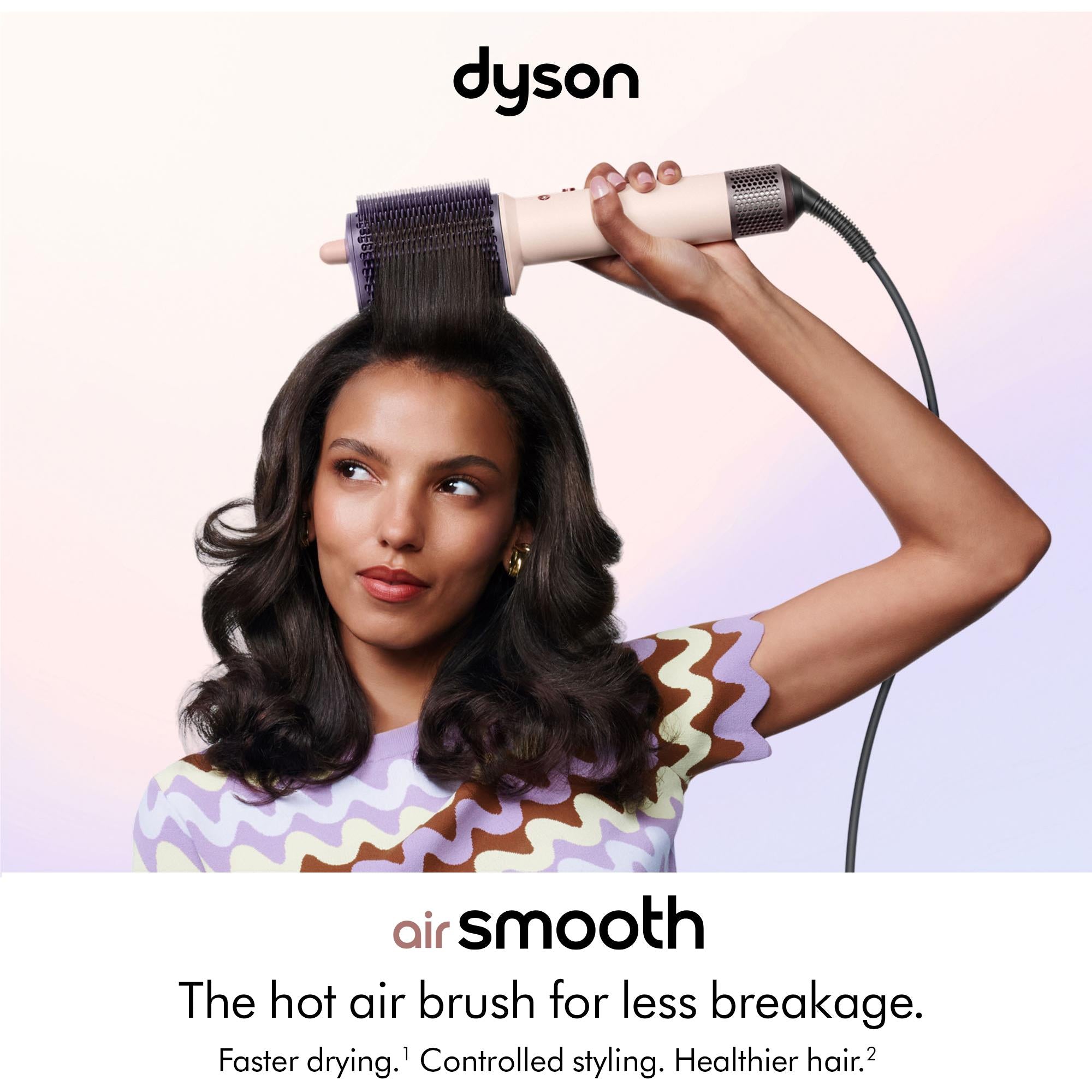 Dyson Airsmooth hot air styling brush held in hand