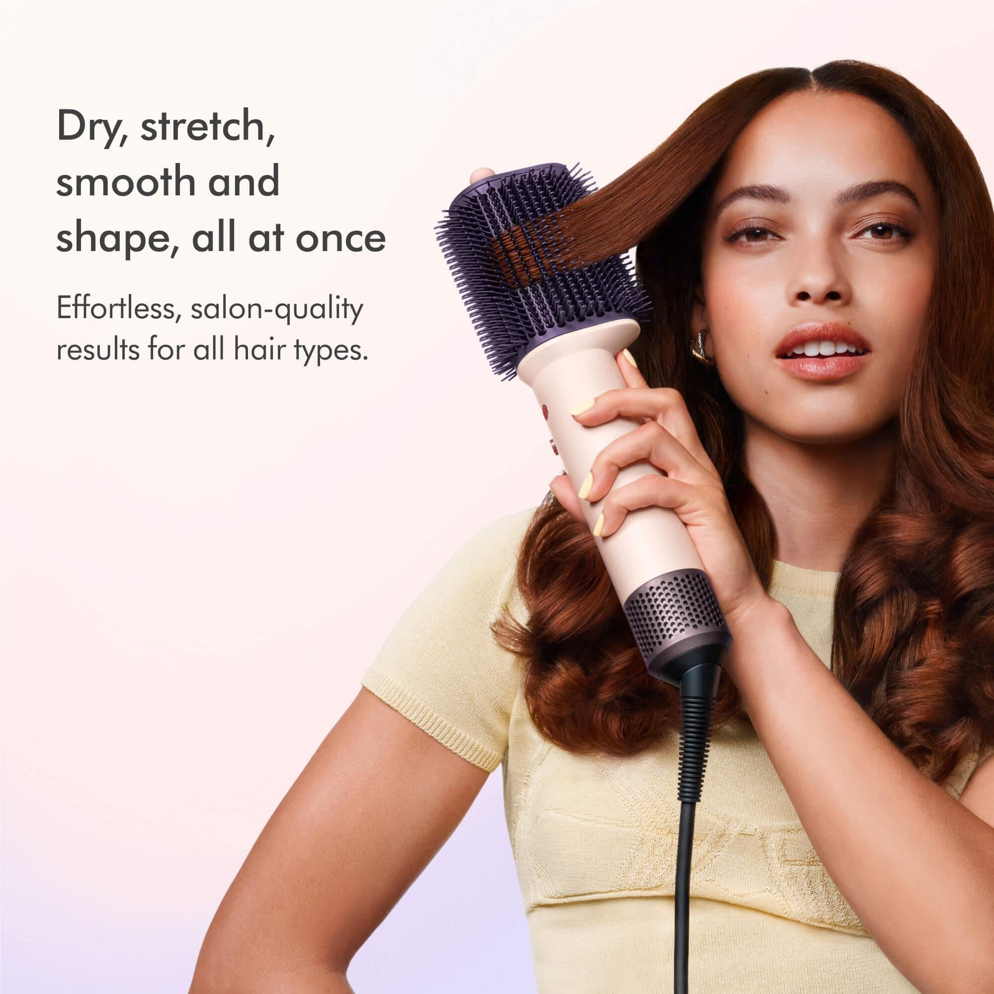 Dyson Airsmooth hot air styling brush in use on long hair