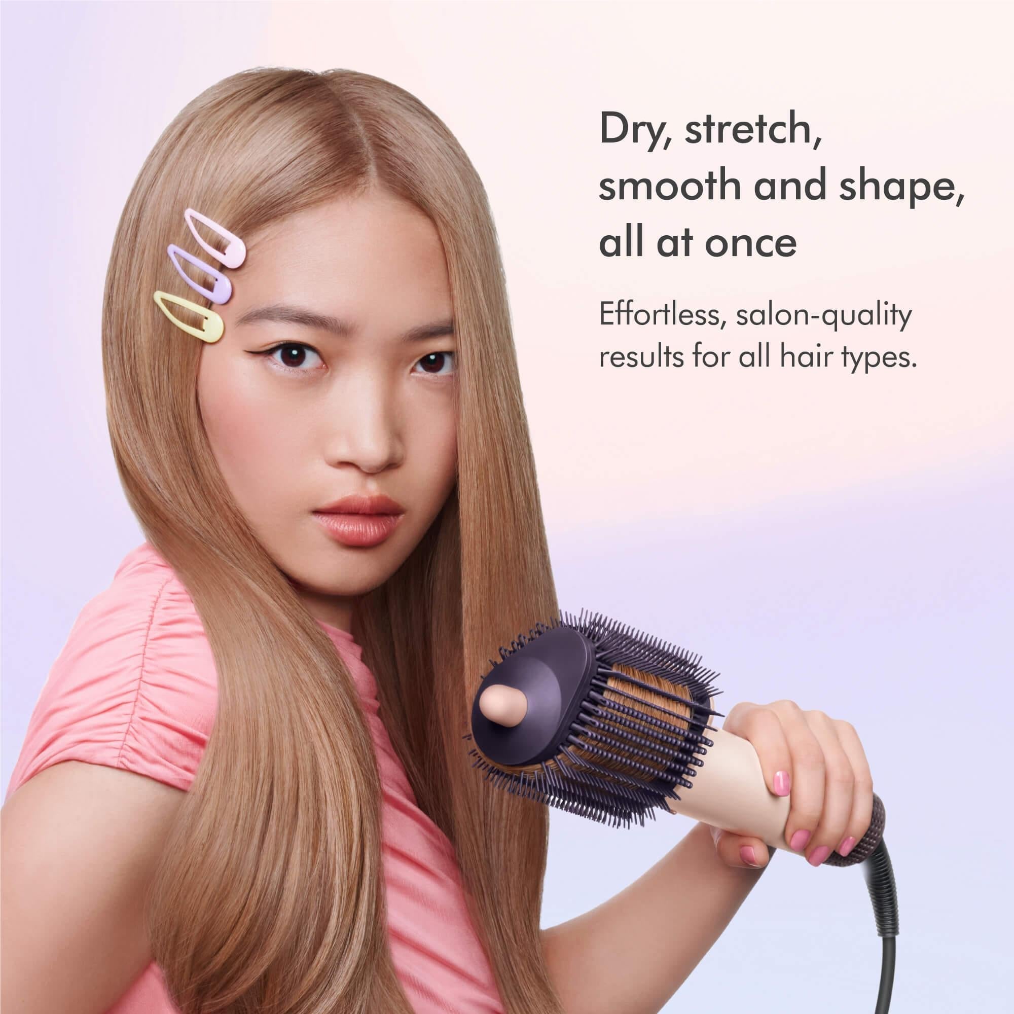Dyson Airsmooth hot air styling brush held near hair for smoothing