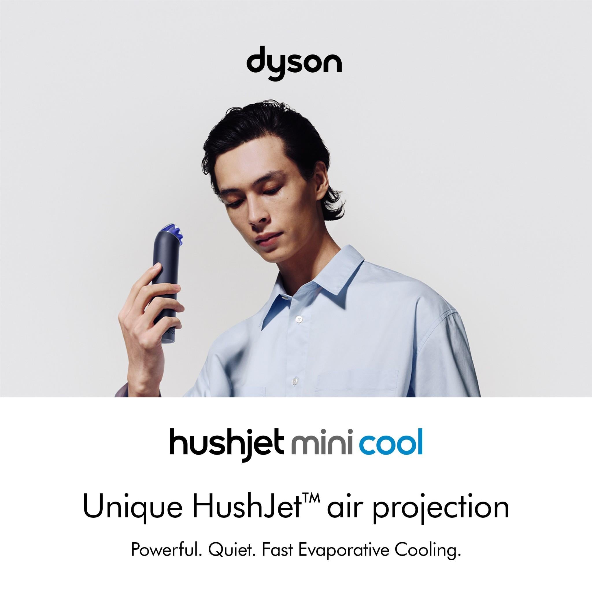 Handheld mini fan in ink navy with cobalt blue top held by a person