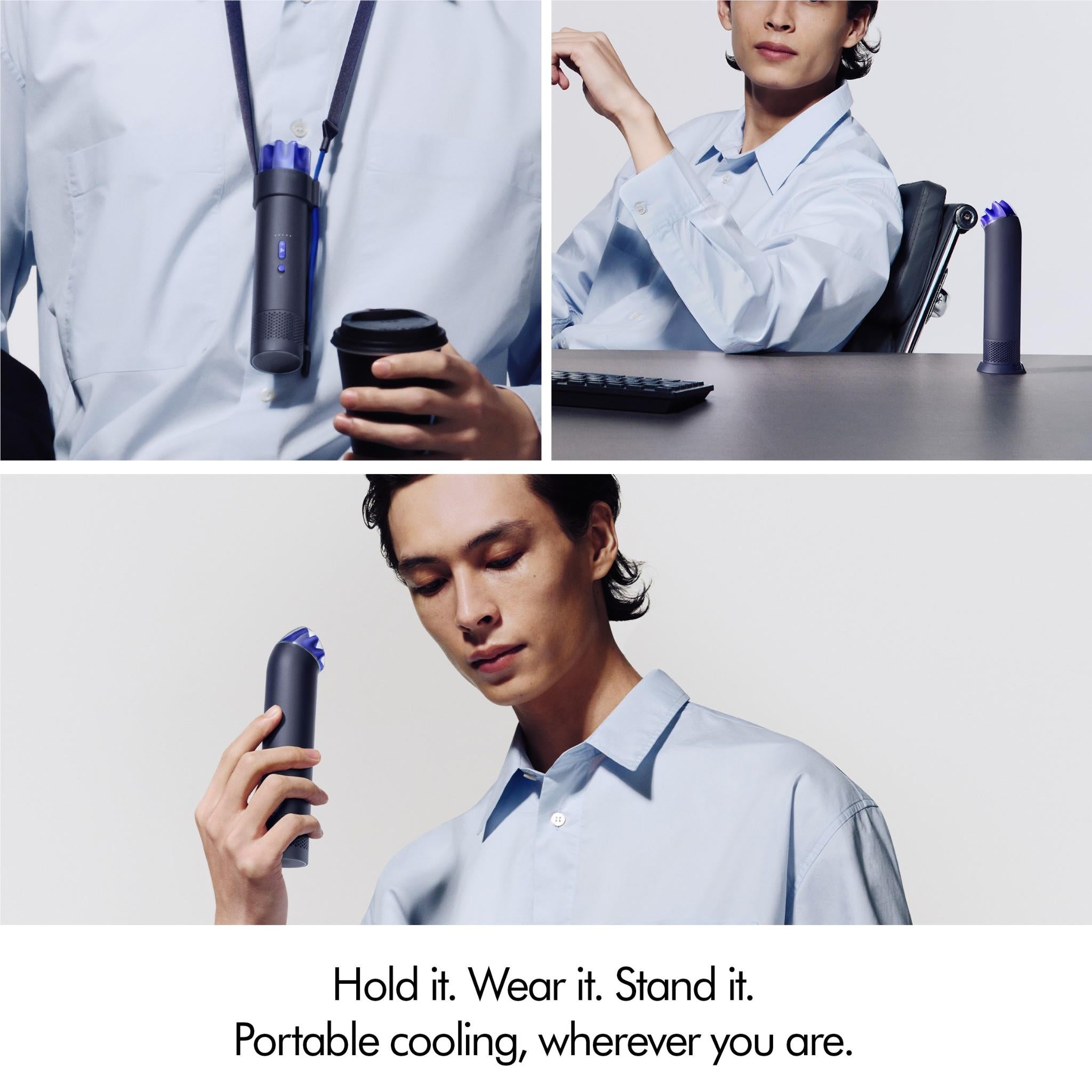 Portable mini fan in ink navy with cobalt blue top on a desk, held nearby