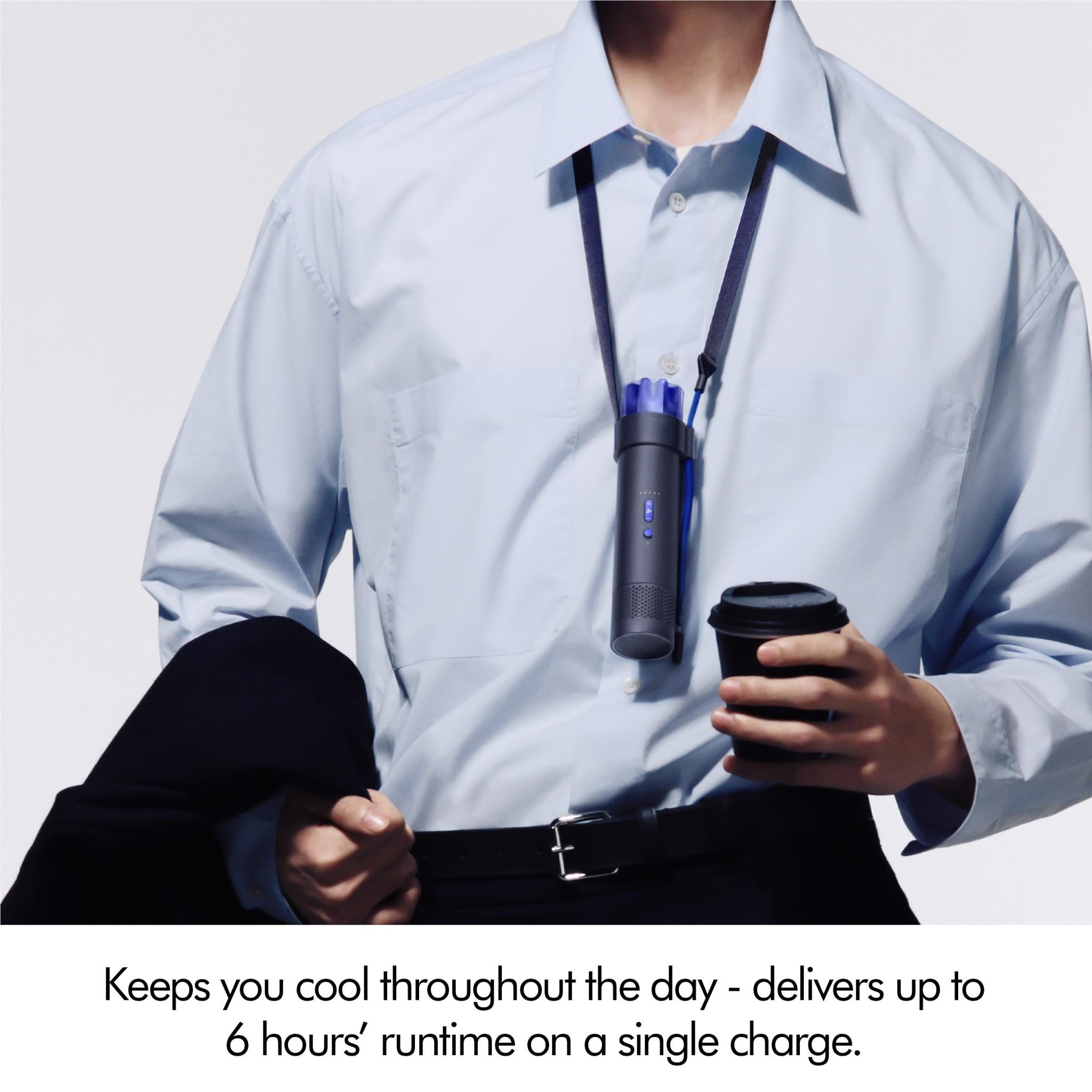 Portable mini fan in ink navy with cobalt blue top held in front of a person