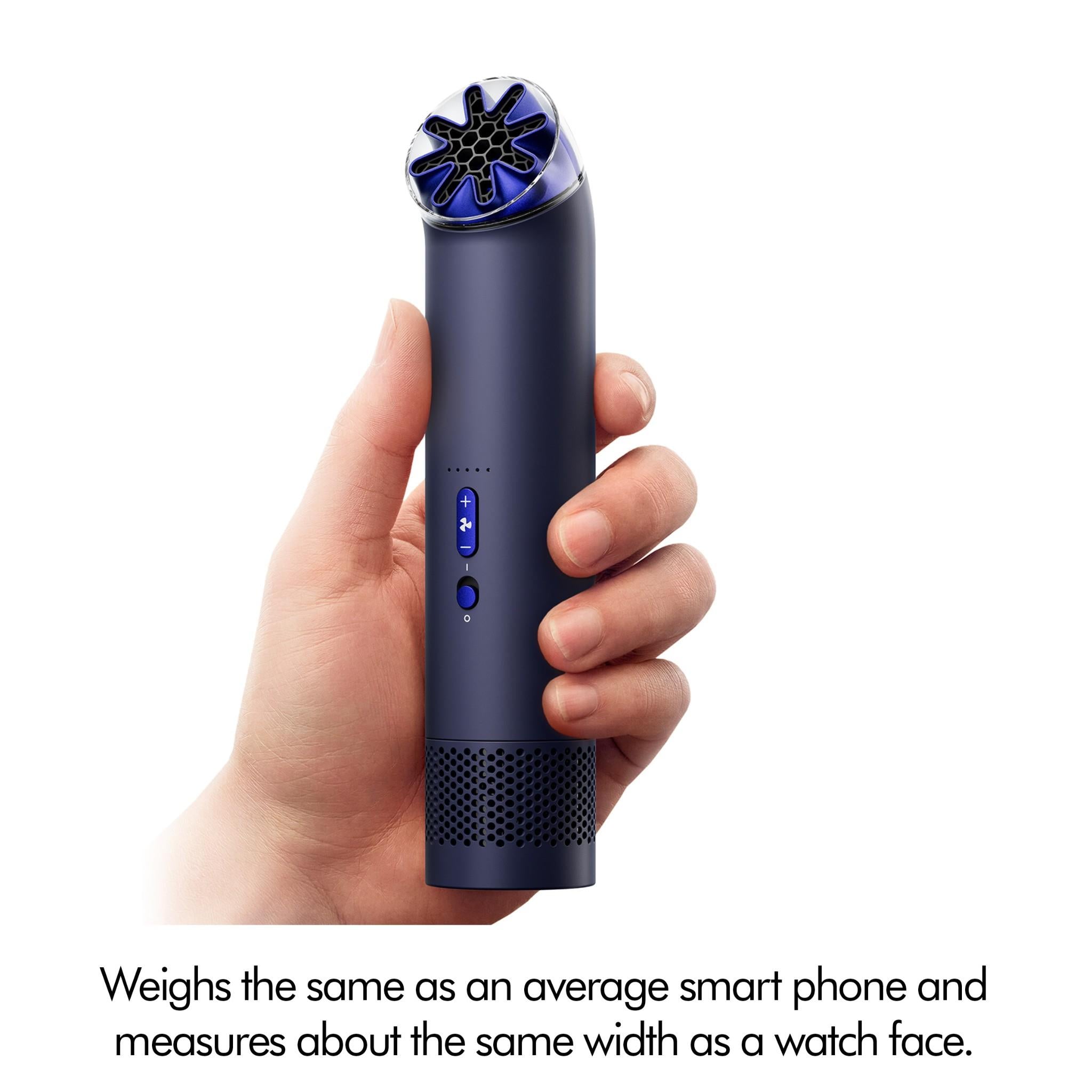 Close-up of handheld mini fan in ink navy with cobalt blue top in hand