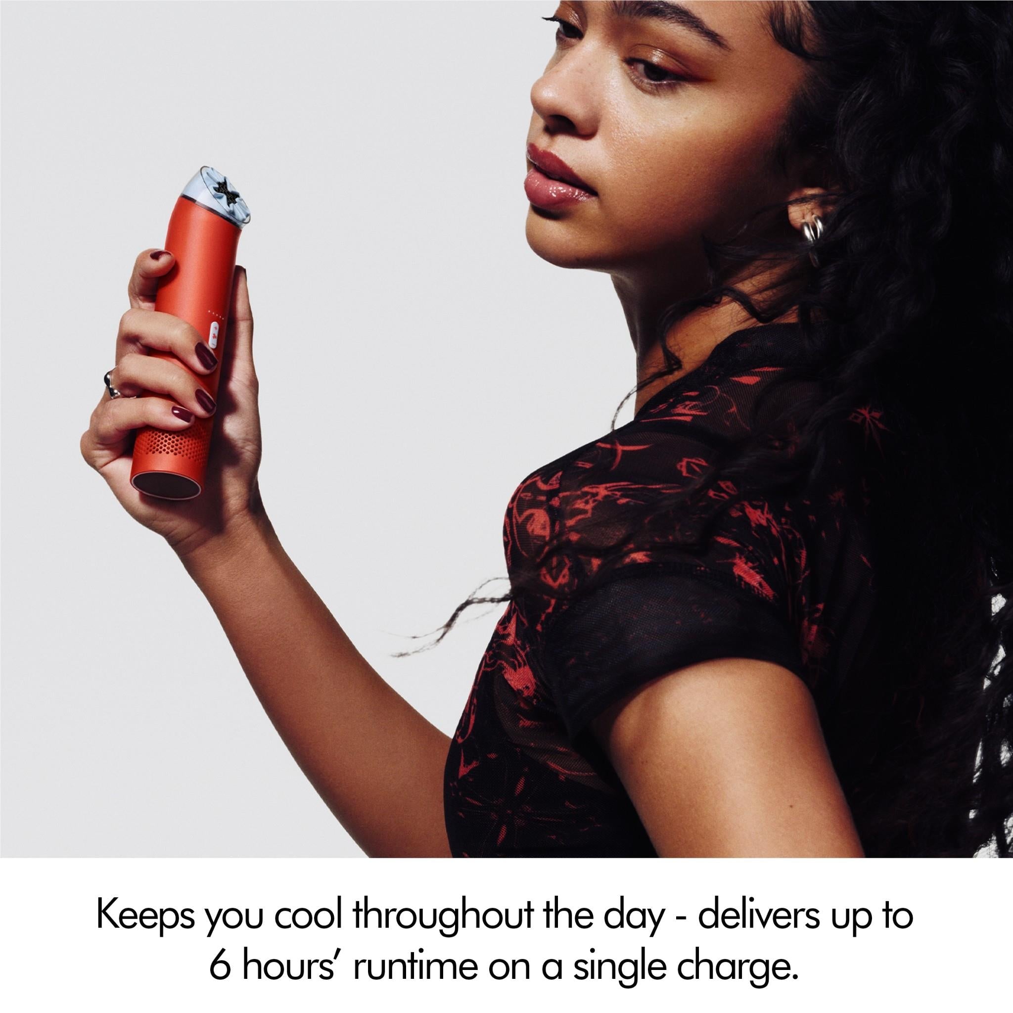 Dyson mini cool handheld fan in carnelian red held in hand