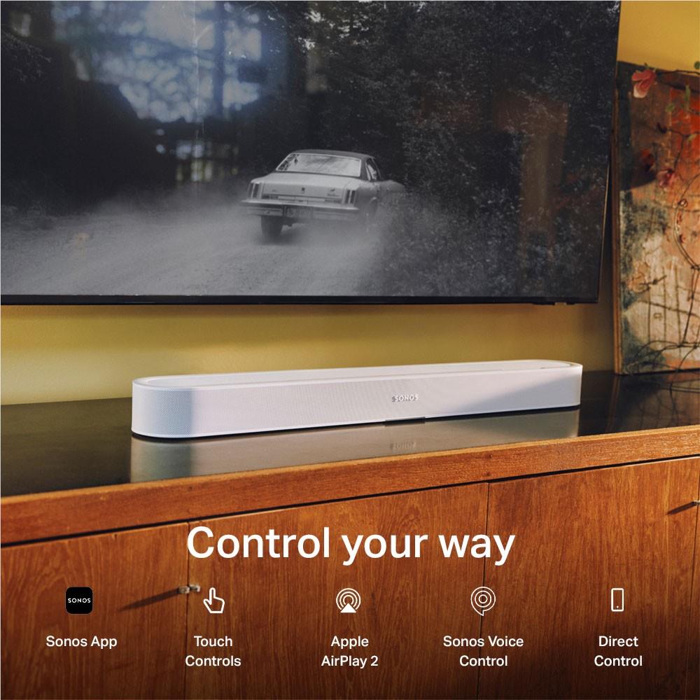 White Sonos Beam Ultra soundbar centered under TV on a wood console