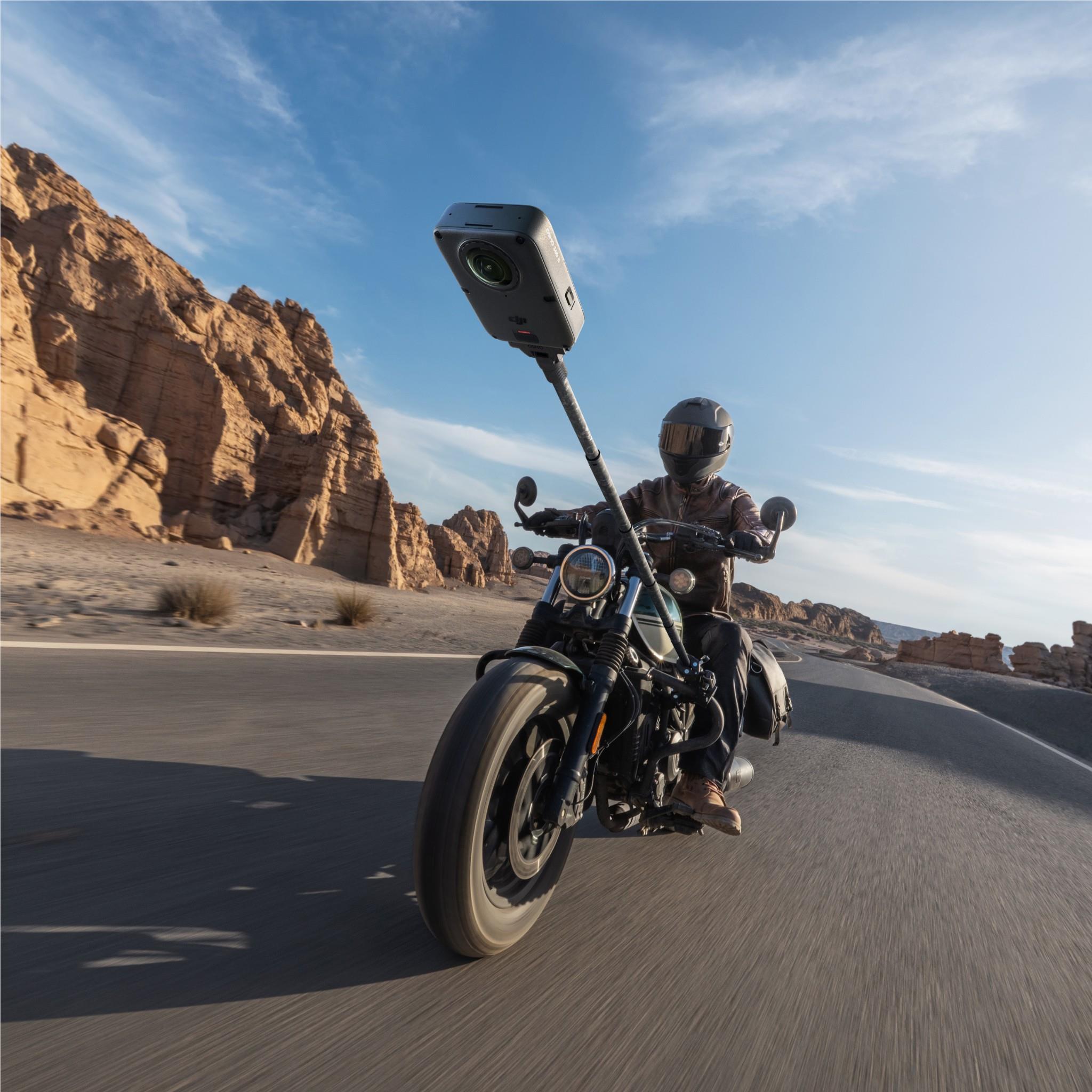 Action camera on a mount attached above a motorcycle rider
