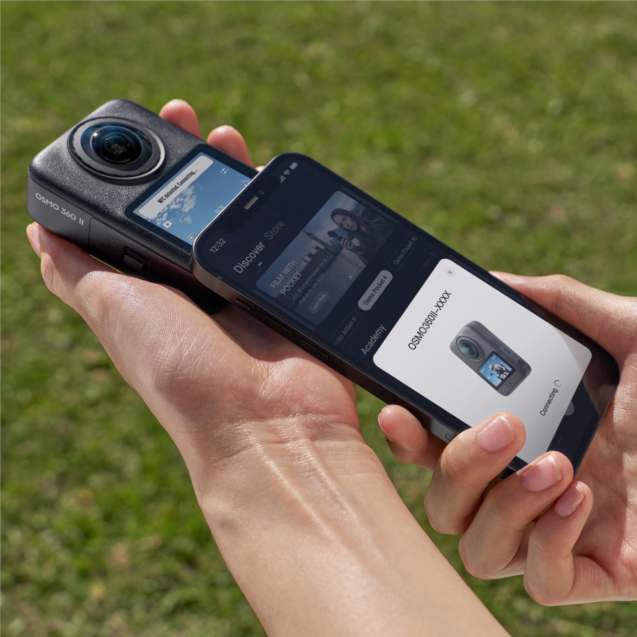 360 action camera with rear screen, held in hands, lens facing left