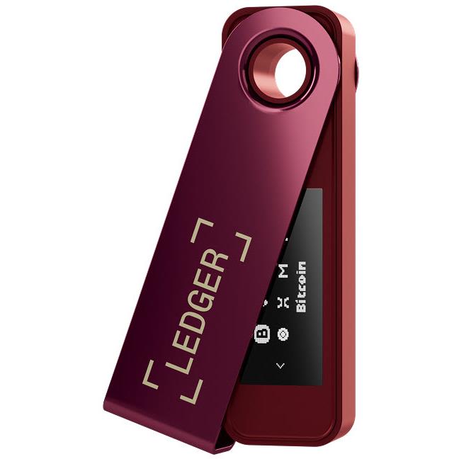 Crimson magenta hardware wallet standing with Ledger text and dark screen, ring hole