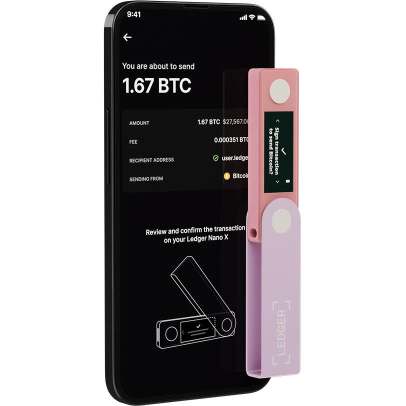 Ledger Nano X hardware wallet, pastel pink, beside smartphone showing send details