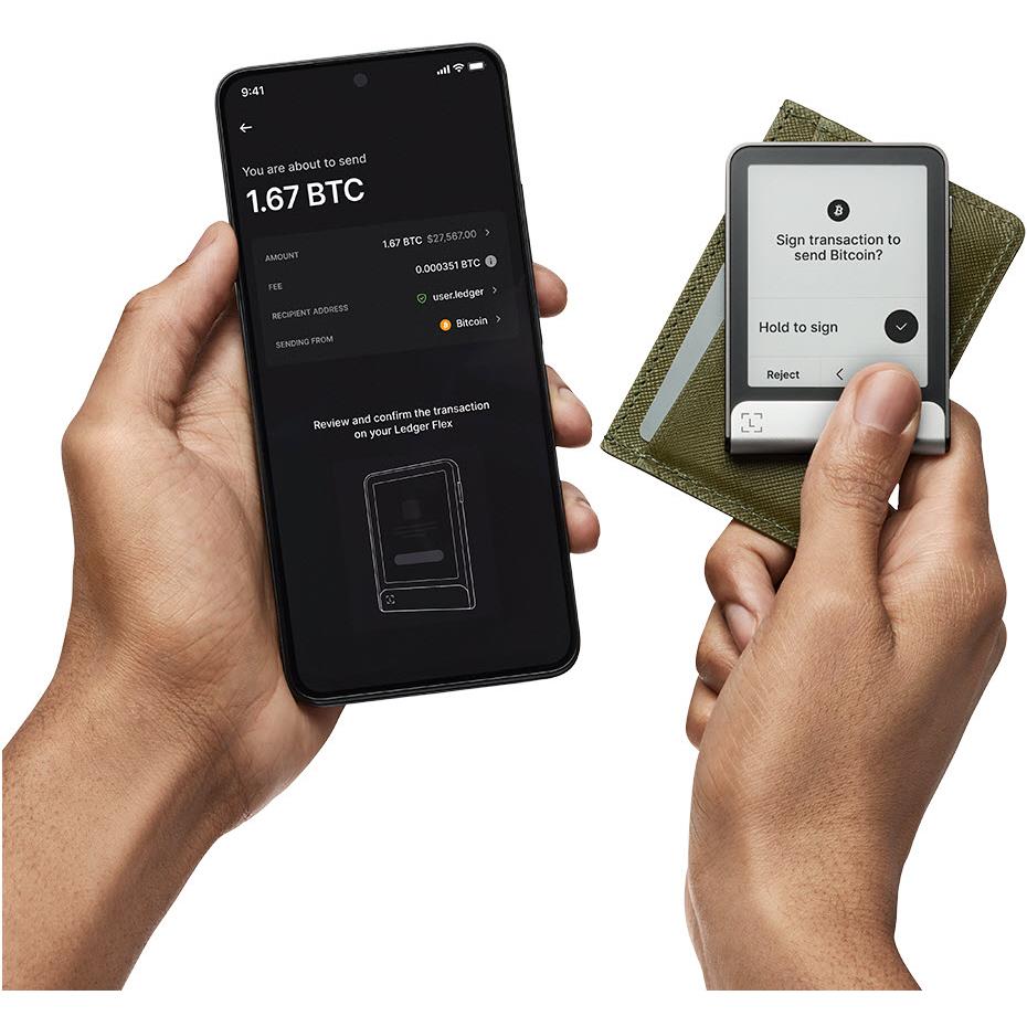 Hands using Ledger Flex with phone and recovery key, prompting sign transaction
