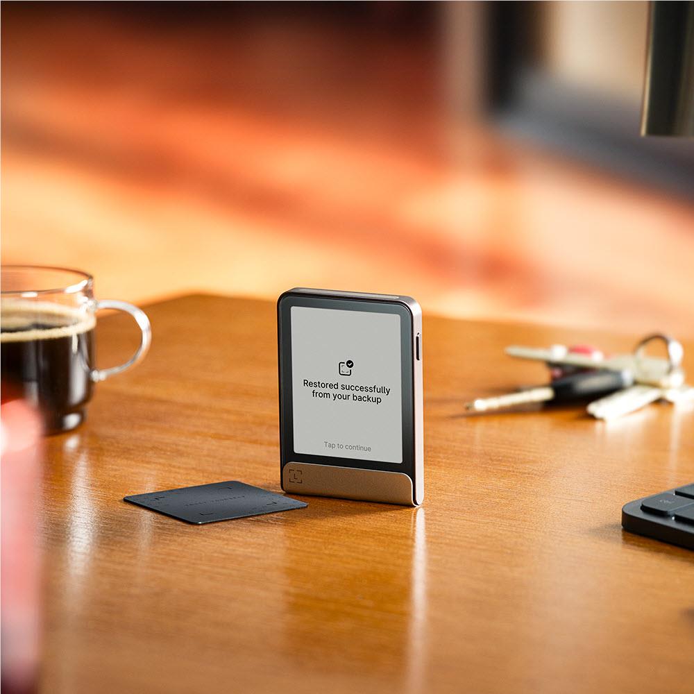 Ledger Flex crypto hardware wallet on stand, screen message restored successfully