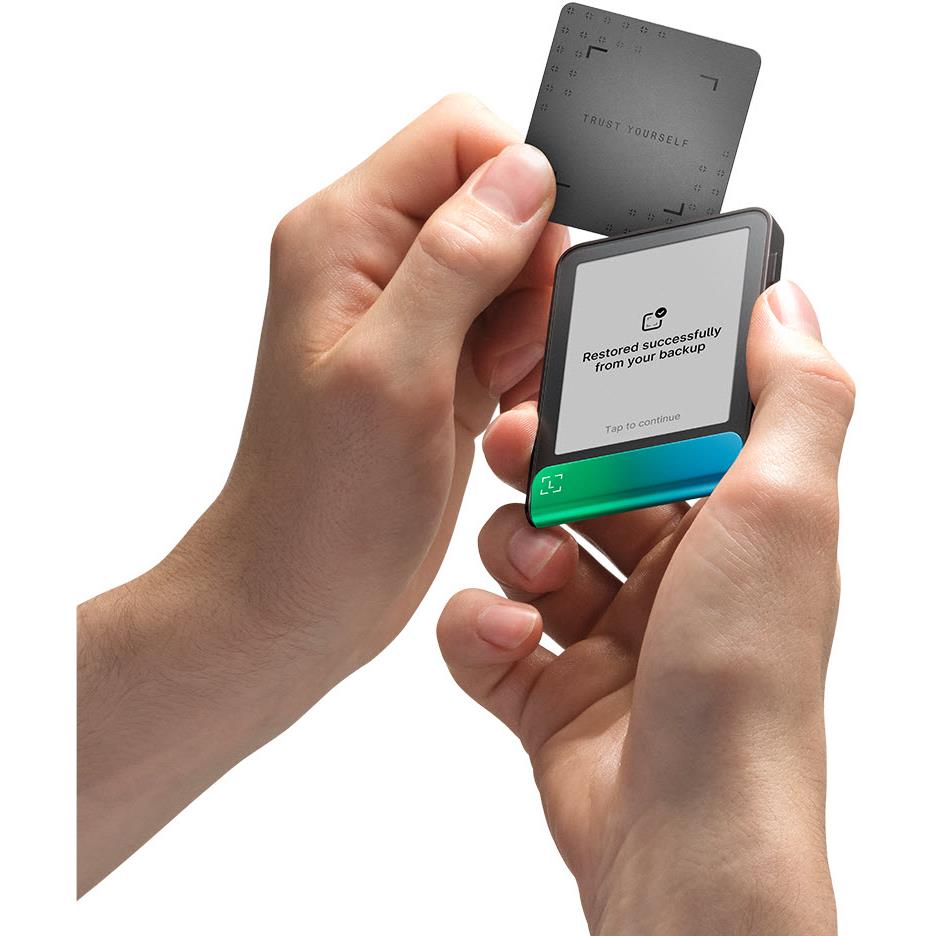 Hands holding cold storage wallet and security confirmation screen