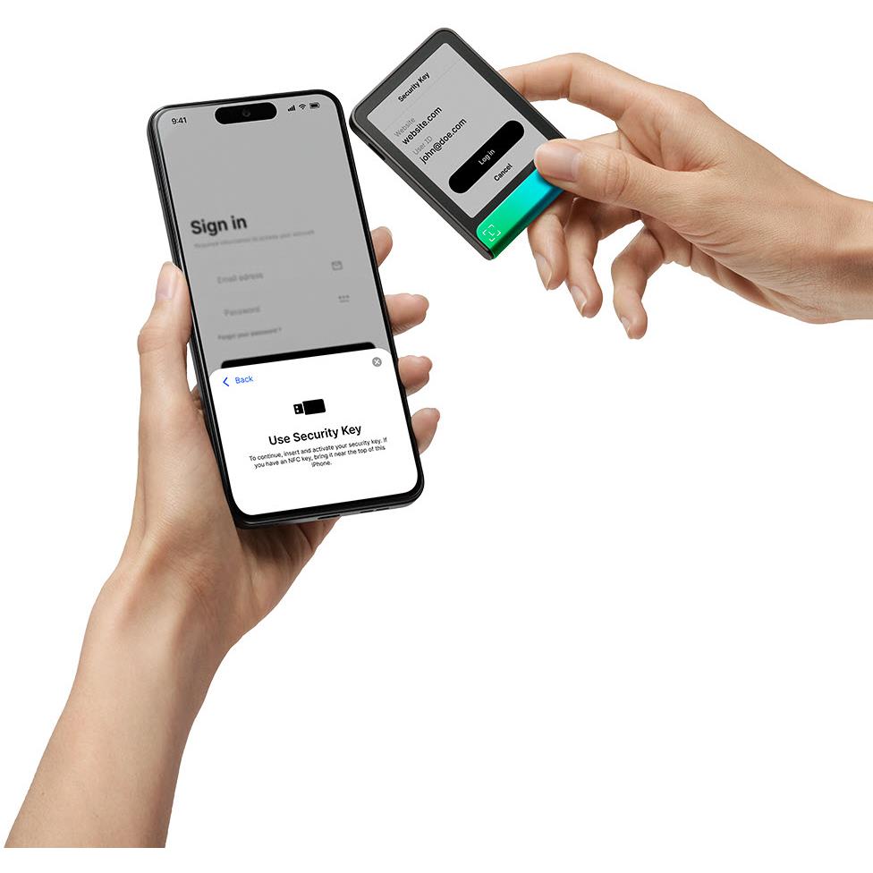 Hands using cold storage wallet to sign in on a phone app