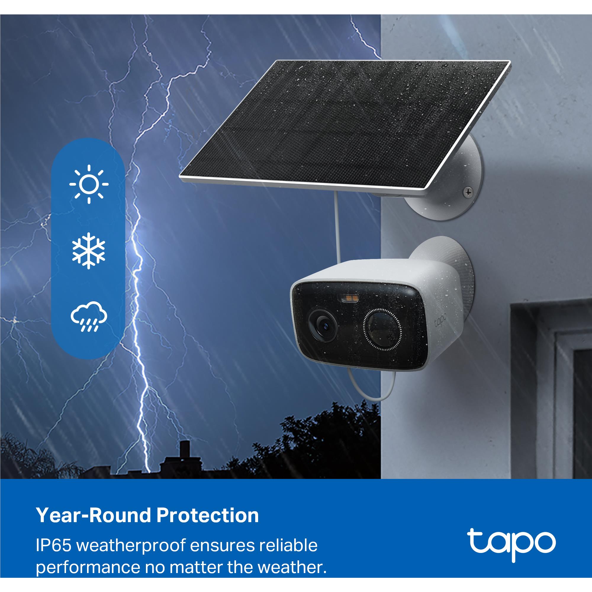 White solar security camera with solar panel outdoors on a building wall