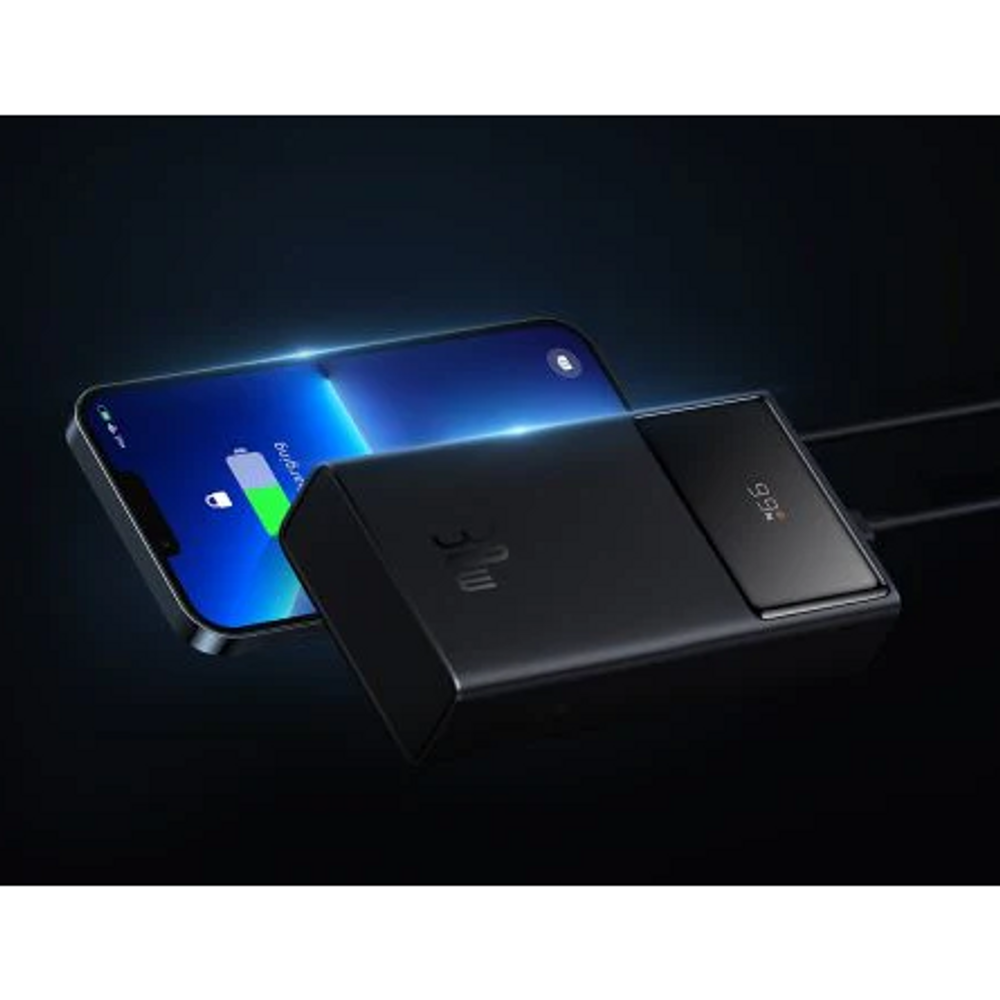 Black power bank charging smartphones with digital display panel on