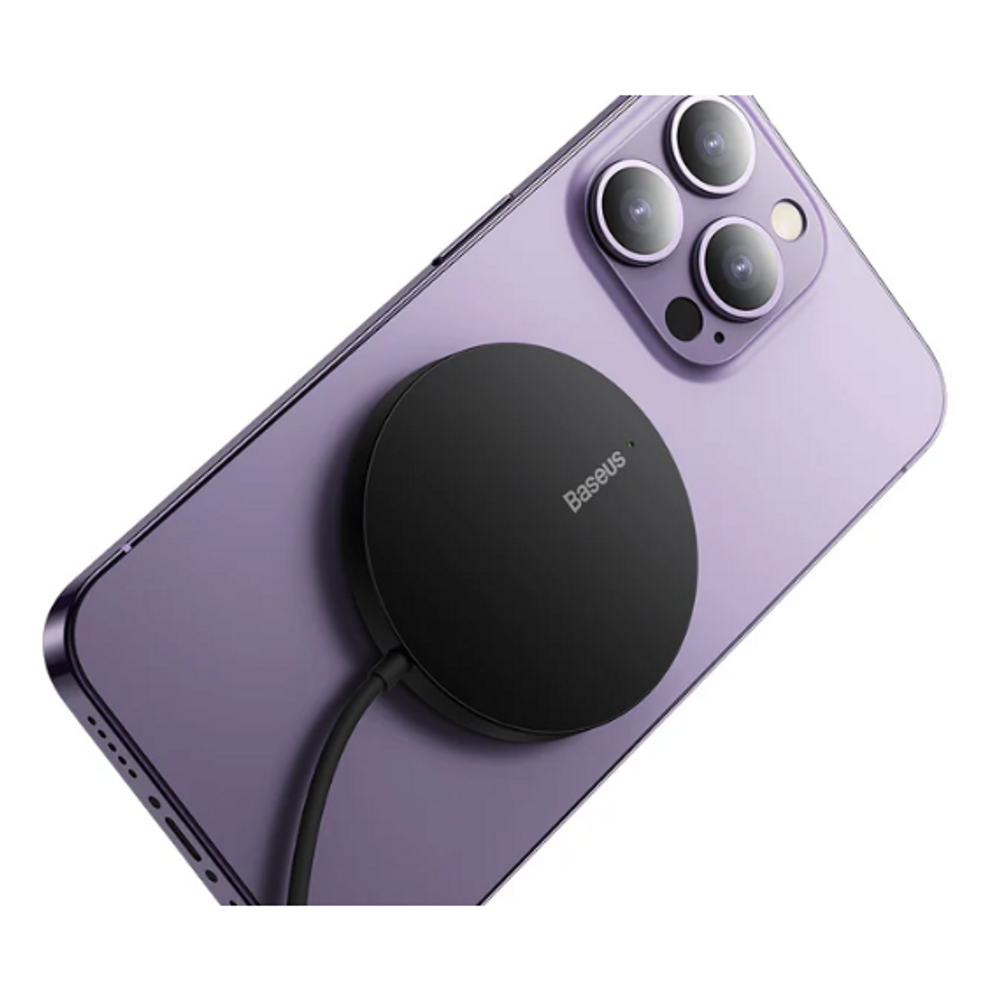 Black circular magnetic wireless charger attached to a light purple phone back