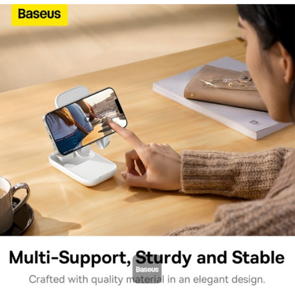 Baseus Moon White folding phone stand holding a smartphone at viewing angle