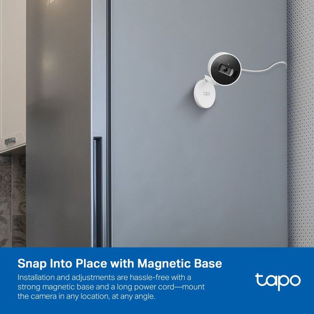 White security camera mounted on a wall with magnetic base and cable