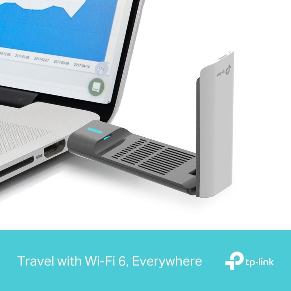 TP-Link Archer TX50UH WiFi USB adapter near laptop with base stand