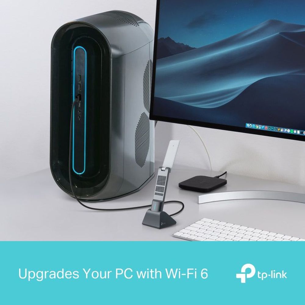 TP-Link Archer TX50UH WiFi adapter connected near desktop router and monitor