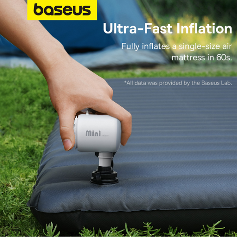 Hand using a white mini air pump to inflate an outdoor air mattress