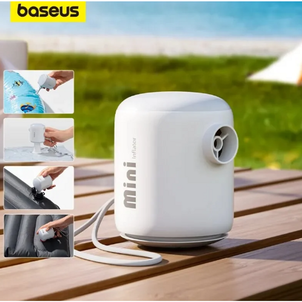 White portable air pump with nozzle and hose on a wooden surface