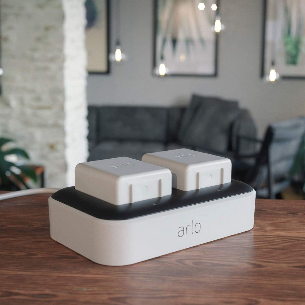 Arlo dual charging station with two white power modules on a black top.