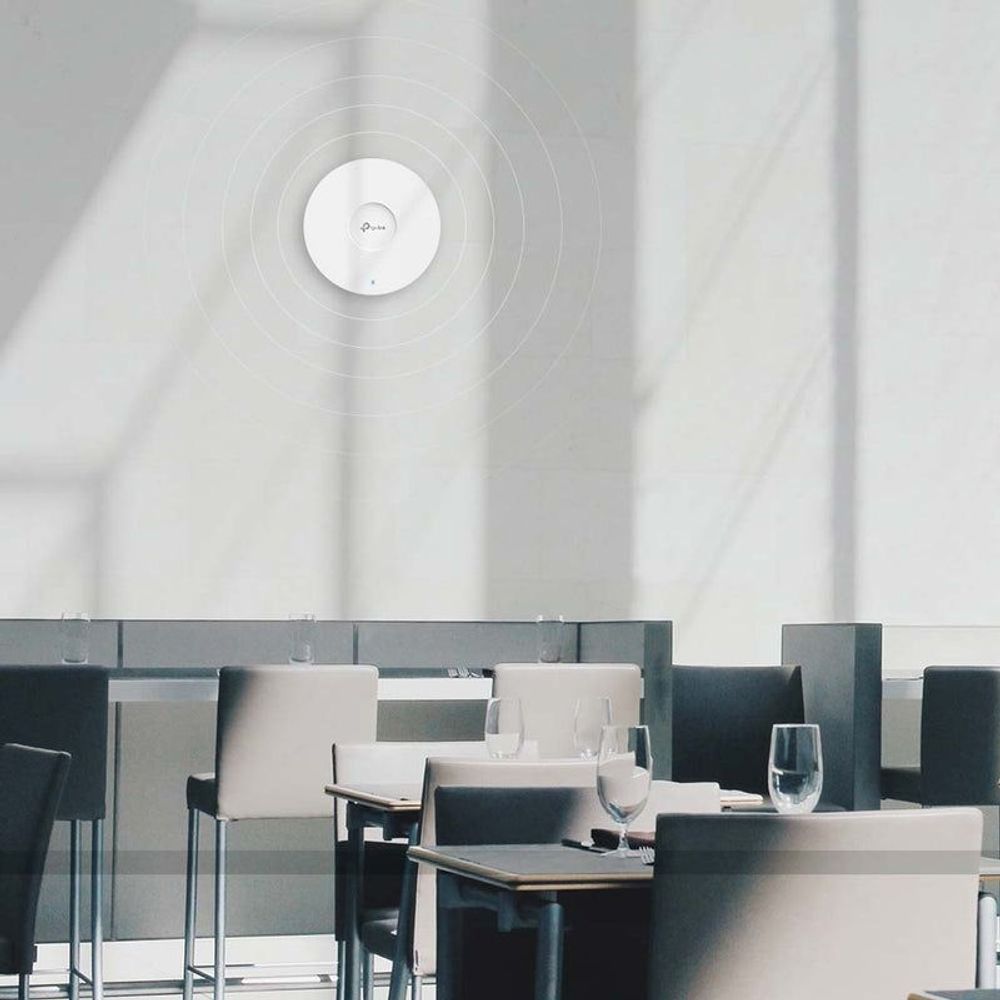TP-Link Omada ceiling-mount access point installed on a ceiling panel