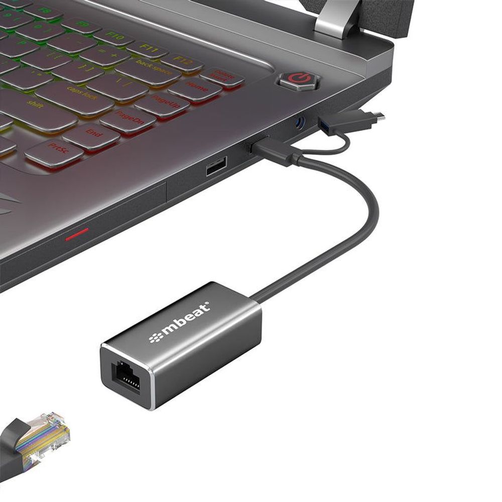 Aluminum mbeat gigabit LAN adapter with RJ45 Ethernet port connected to laptop