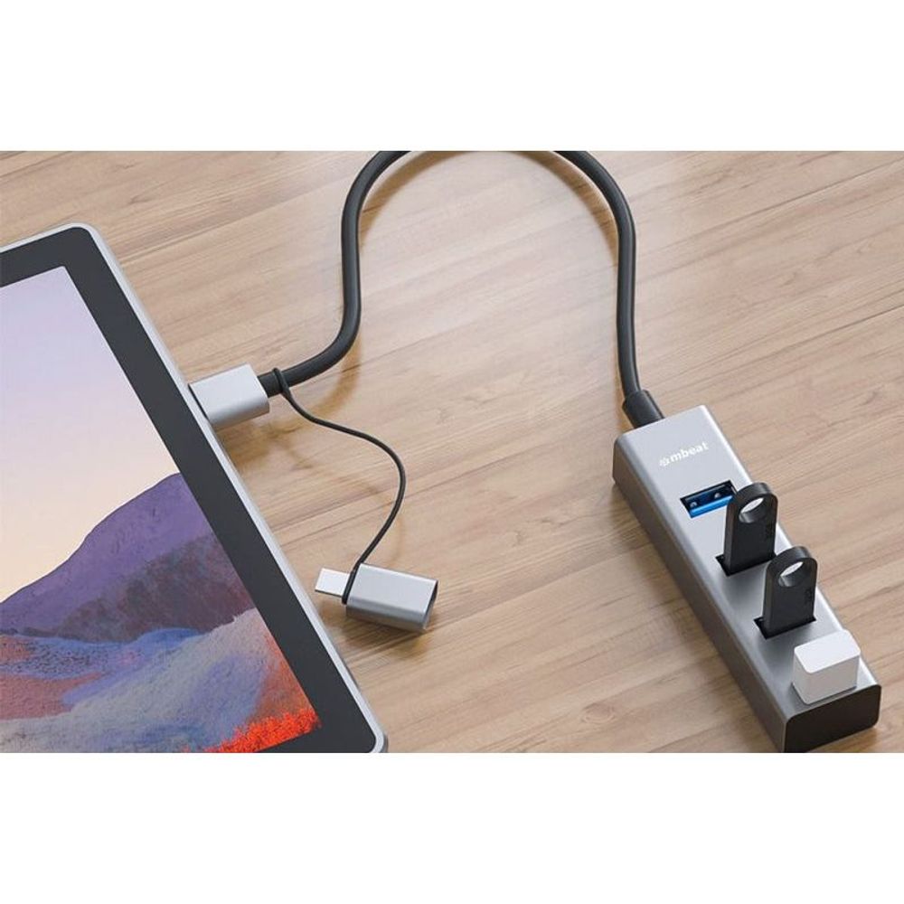 Space gray 4-port USB hub with USB-C converter, connected cables with blue USB ports