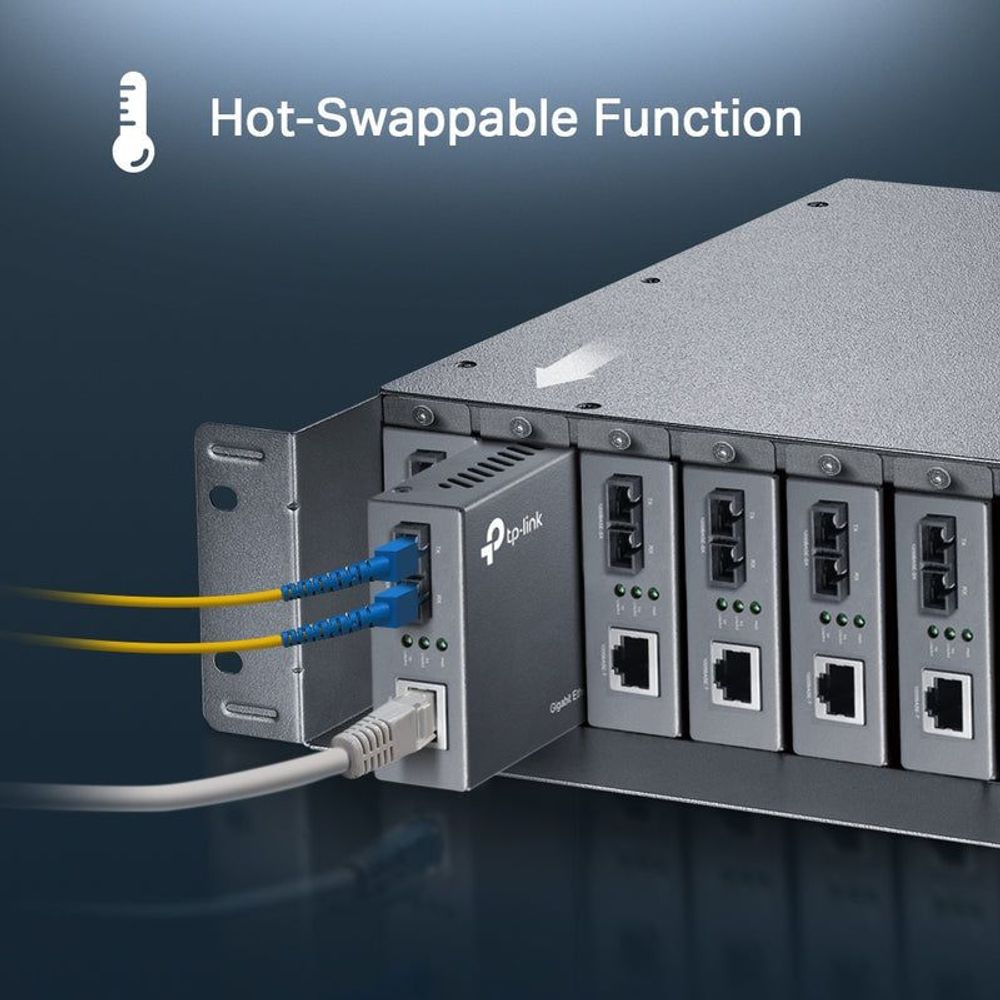 TP-Link media converter chassis showing hot-swappable module area with connected cables