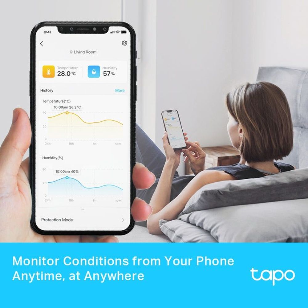 Smart temperature and humidity monitor app on smartphone, held by a person