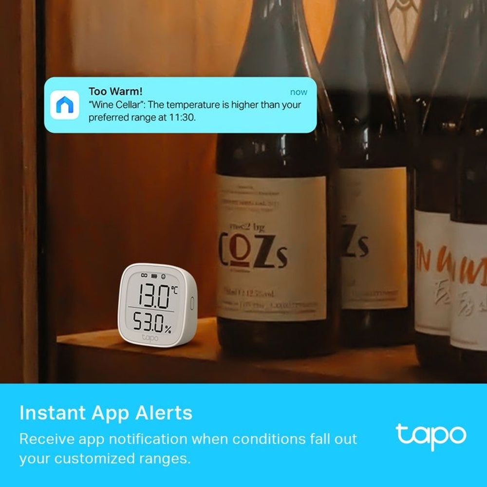 Smart temperature and humidity monitor sitting on a shelf with temperature and humidity display