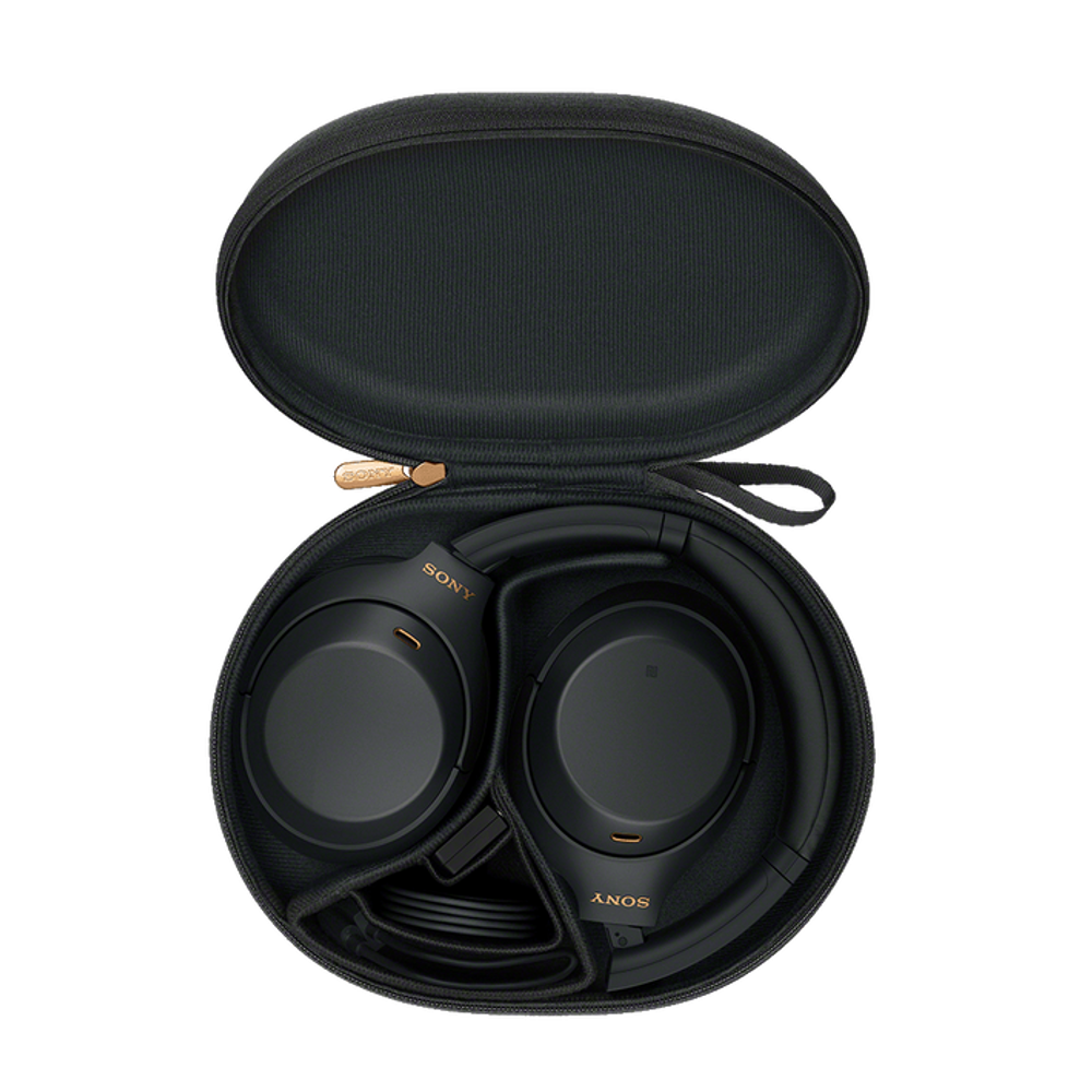Black over-ear headphones in a hard carrying case with open lid
