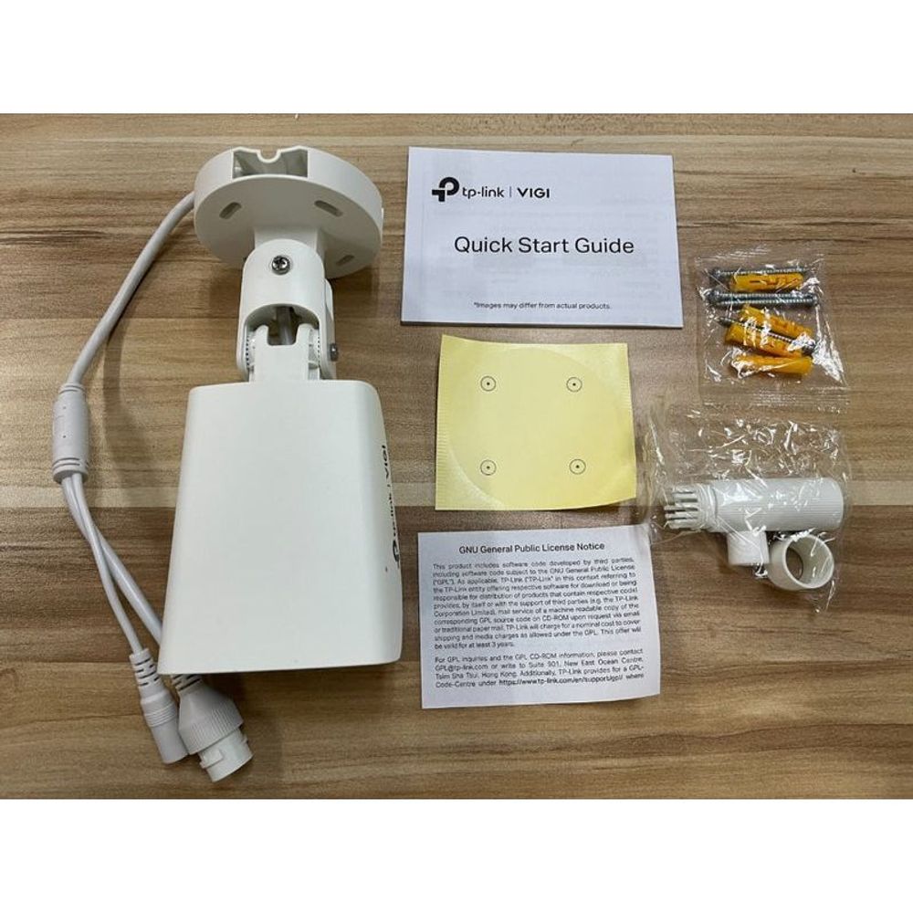 Outdoor bullet camera kit with wall mount, cables, screws, and quick start guide.