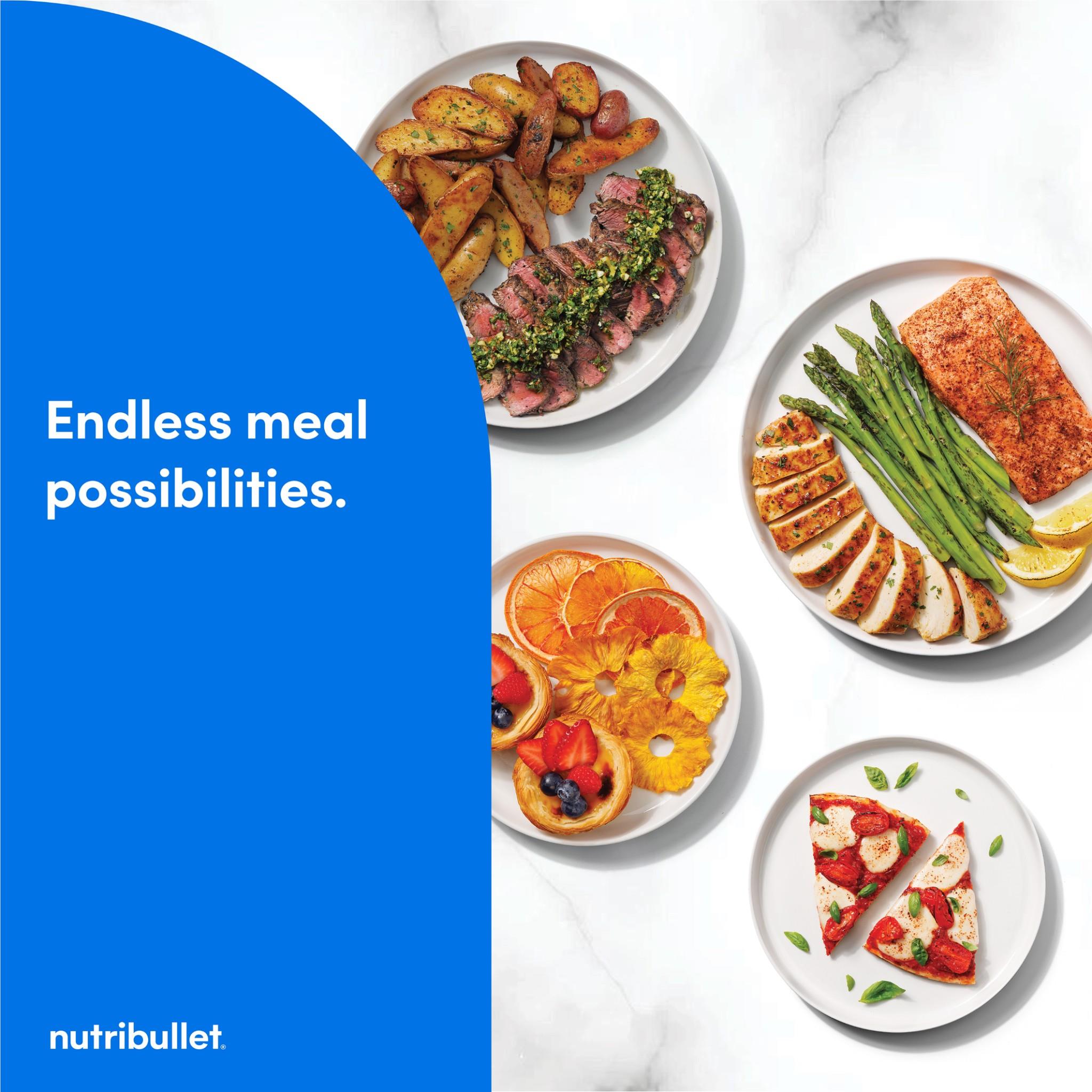 Dual-basket air fryer countertop scene with plates of cooked food